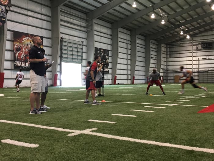 Billy Napier watches walk-ons participate in workouts inside Louisiana’s indoor facility.